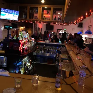 a bar with people sitting at the bar