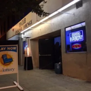 a photo of a sign in front of a building