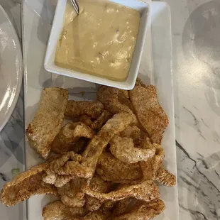 Pork skins with cheese sauce