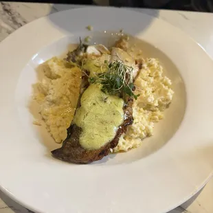 Evening Special. Trout stuffed with crab served with savory grits and a lemony herb sauce.