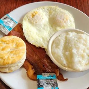 The Mama Mary breakfast with grits, biscuit  and bacon with over easy eggs