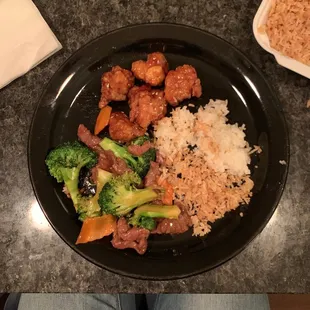 a plate of food with rice and broccoli