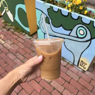 a hand holding a cup of coffee