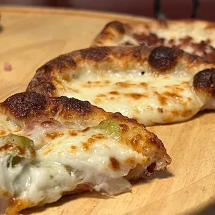 two slices of pizza on a cutting board
