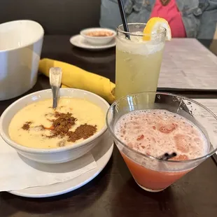 a woman sitting at a table with a bowl of soup and a bowl of soup