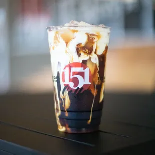 a cup of iced coffee on a table