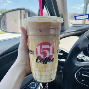 a hand holding a cup of coffee