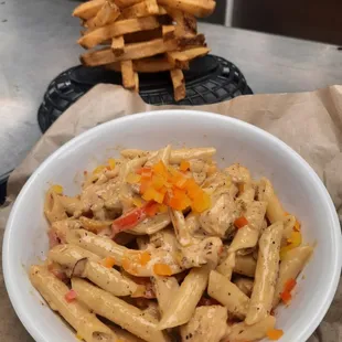 a bowl of pasta and fries