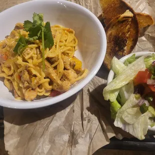a plate of pasta and salad