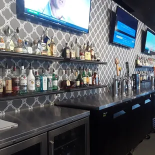 a bar with a lot of bottles on the shelves