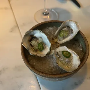 Oyster, finger lime, coconut milk, jalapenos. Amazing!