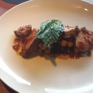 Pumpkin seed crusted pork loin, chickpeas, braised spinach