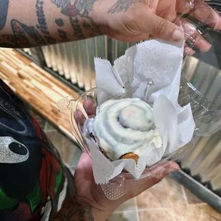 a person holding a cupcake