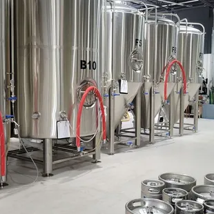 a row of stainless steel tanks