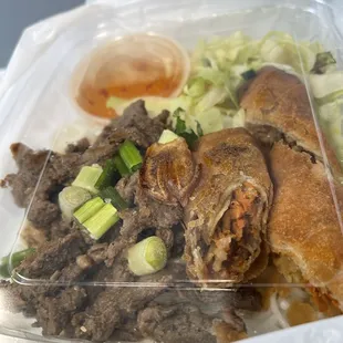 a close up of a plastic container with meat and vegetables