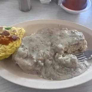 Biscuits and homemade gravy and sausage with a half of omelette.