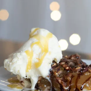 Pecan pie drizzled with a chocolate sauce, served with ice cream and our chef created bourbon sauce