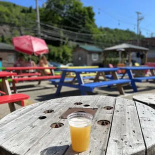 a pint of beer on a picnic table
