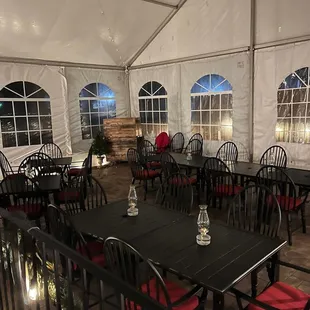 tables and chairs set up in a tent