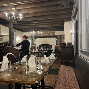 a man setting a table in a restaurant