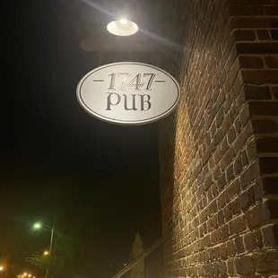 a brick building with a sign for the pub