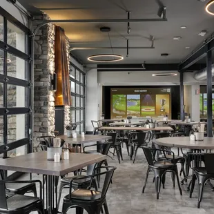 tables and chairs in a restaurant with large windows
