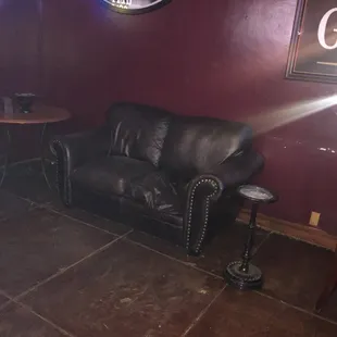 a leather couch in a dimly lit room