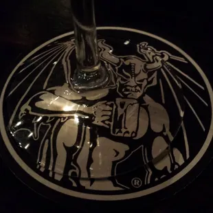 a glass of wine with a drawing on it