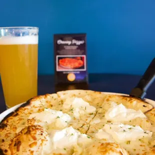 a pizza and a glass of beer