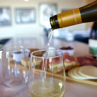 a bottle of wine being poured into a glass