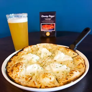 a pizza and a beer on a table