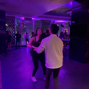 a couple dancing in a dance studio