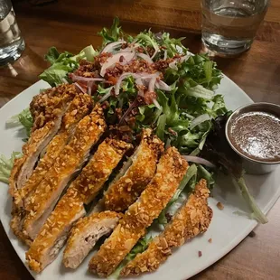 a plate of chicken and salad