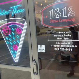 entrance with hours posted on door