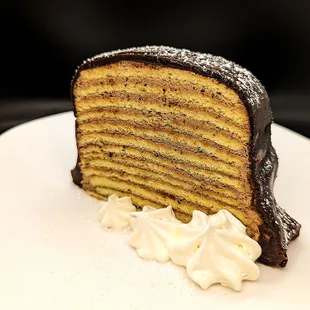 Hungarian Dobos Torte.  Layers of sponge cake and chocolate buttercream.  Topped with dark chocolate ganache.