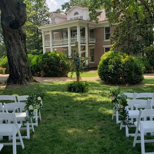 Seating area, outside setting up for a wedding.  Beautiful grounds. Friendship benches. The mission to build friendships stop depression.