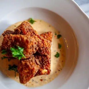 a plate of fried chicken with gravy sauce