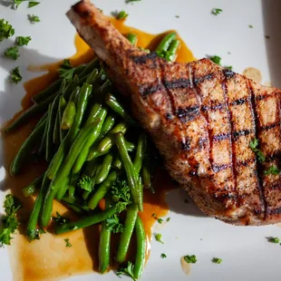 a grilled pork chop and green beans