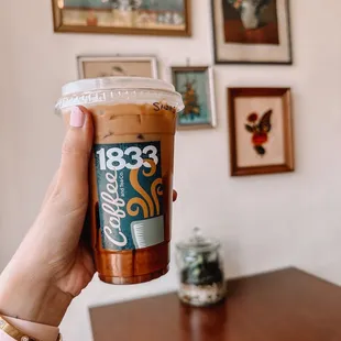 a hand holding a cup of coffee