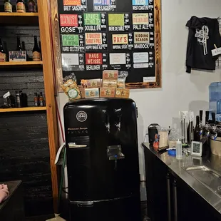 a black refrigerator in a bar