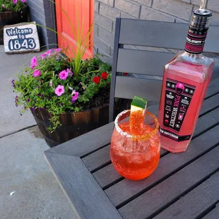 a pink cocktail with a lime garnish garnish garnish garnish garnish garn