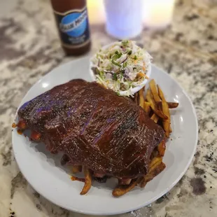 a plate of ribs and french fries