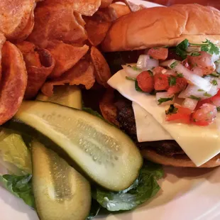 Fiesta Burger with fresh potato chips. A certified Angus burger topped with fresh jalapeños, pico de gallo and pepper jack cheese.