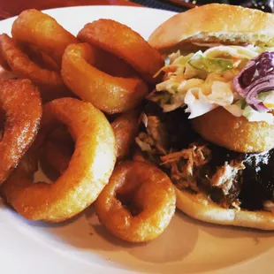 Ozark Pulled Pork with onion rings. BBQ pulled pork topped with creamy slaw and an onion ring.