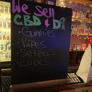 a blackboard with a sign that says we sell cbd