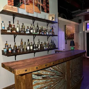 a bar with shelves of liquor