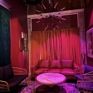a living room with pink lighting