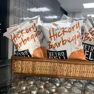 a basket of bread and cans of beer