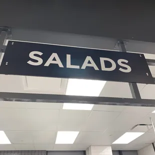 a salads sign hanging from the ceiling