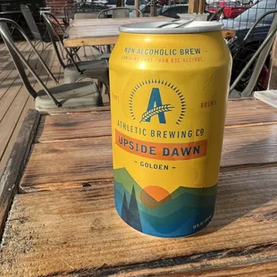 a can of beer on a wooden table